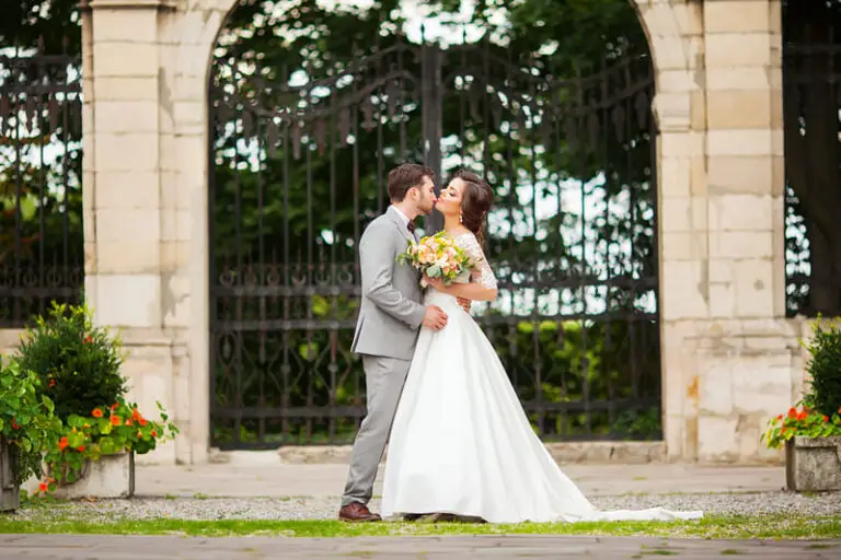 bride-and-groom-in-a-park-kissing-newlyweds-bride-2025-02-12-05-45-03-utc (1) (1)